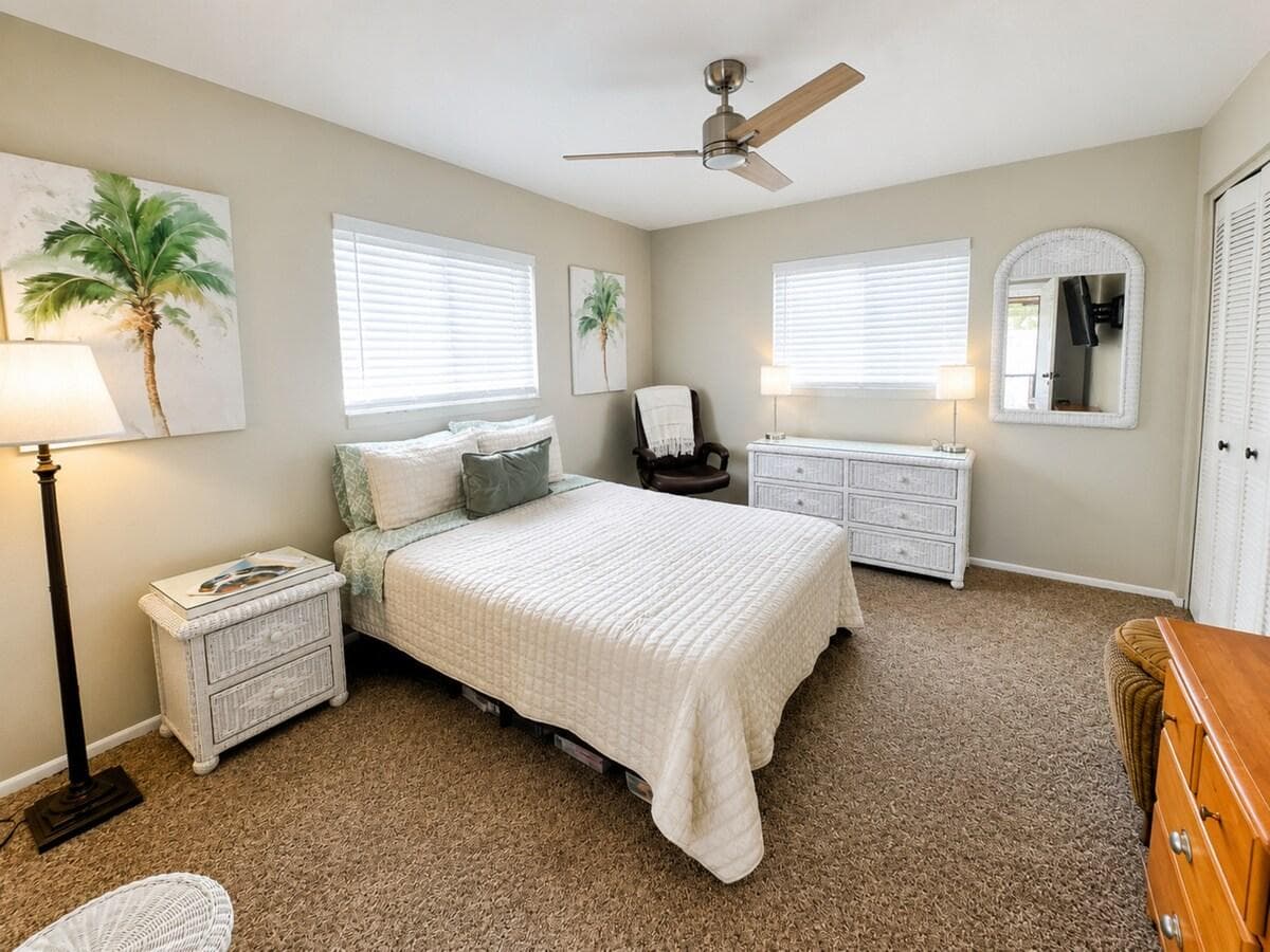 Large queen bed bedroom #1 off of living area with private 65” smart TV on the wall.